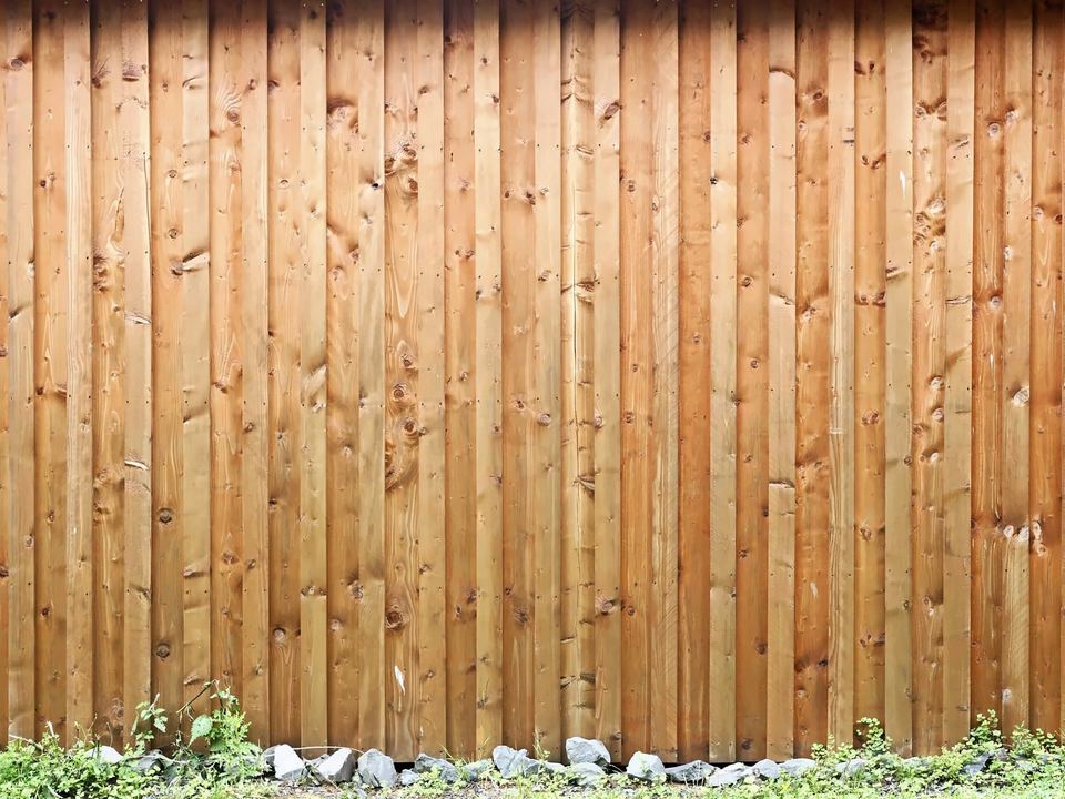 A run of closeboard timber fencing over a gravel board